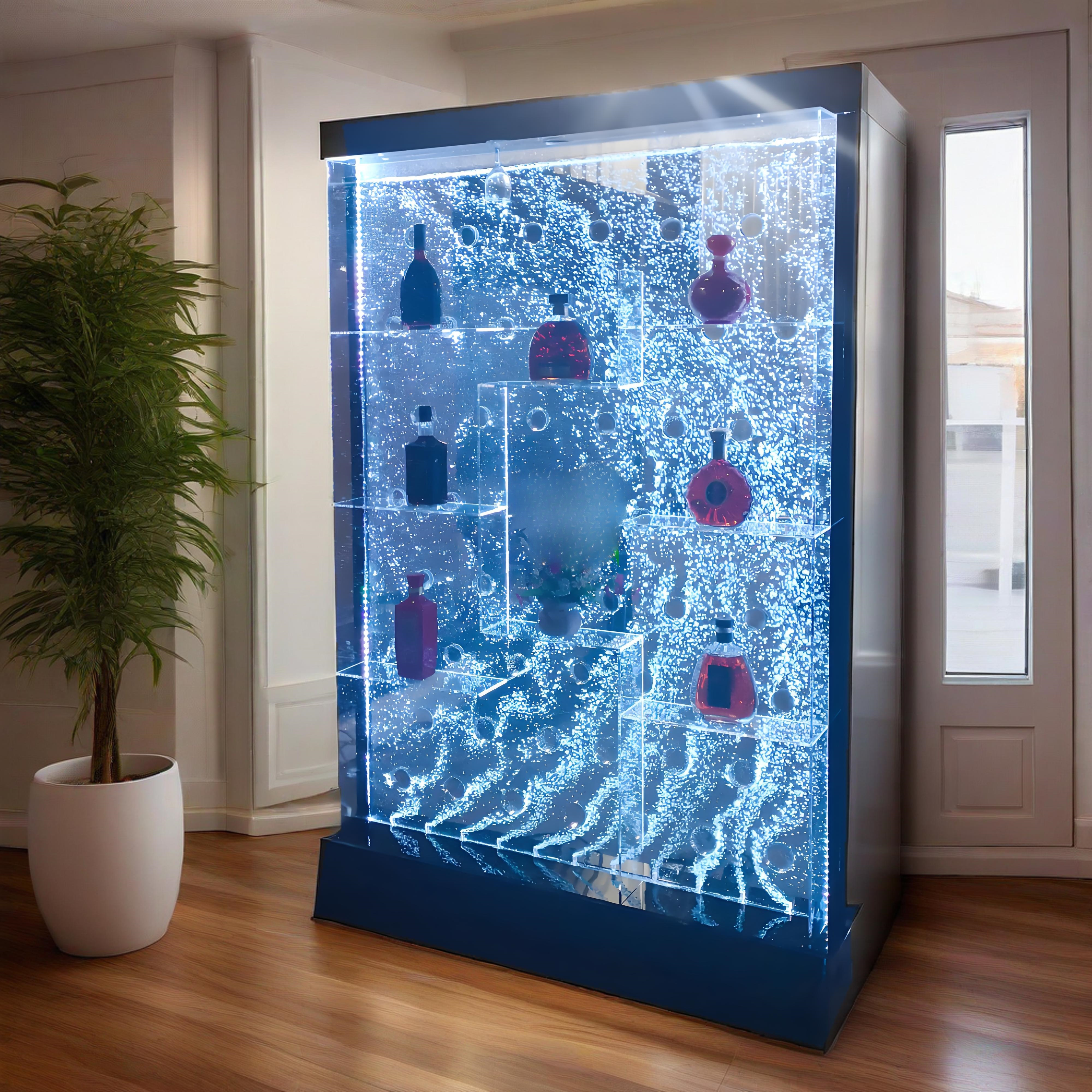 Futuristic display case with glowing blue interior and bottles inside, in a room with a plant and door.