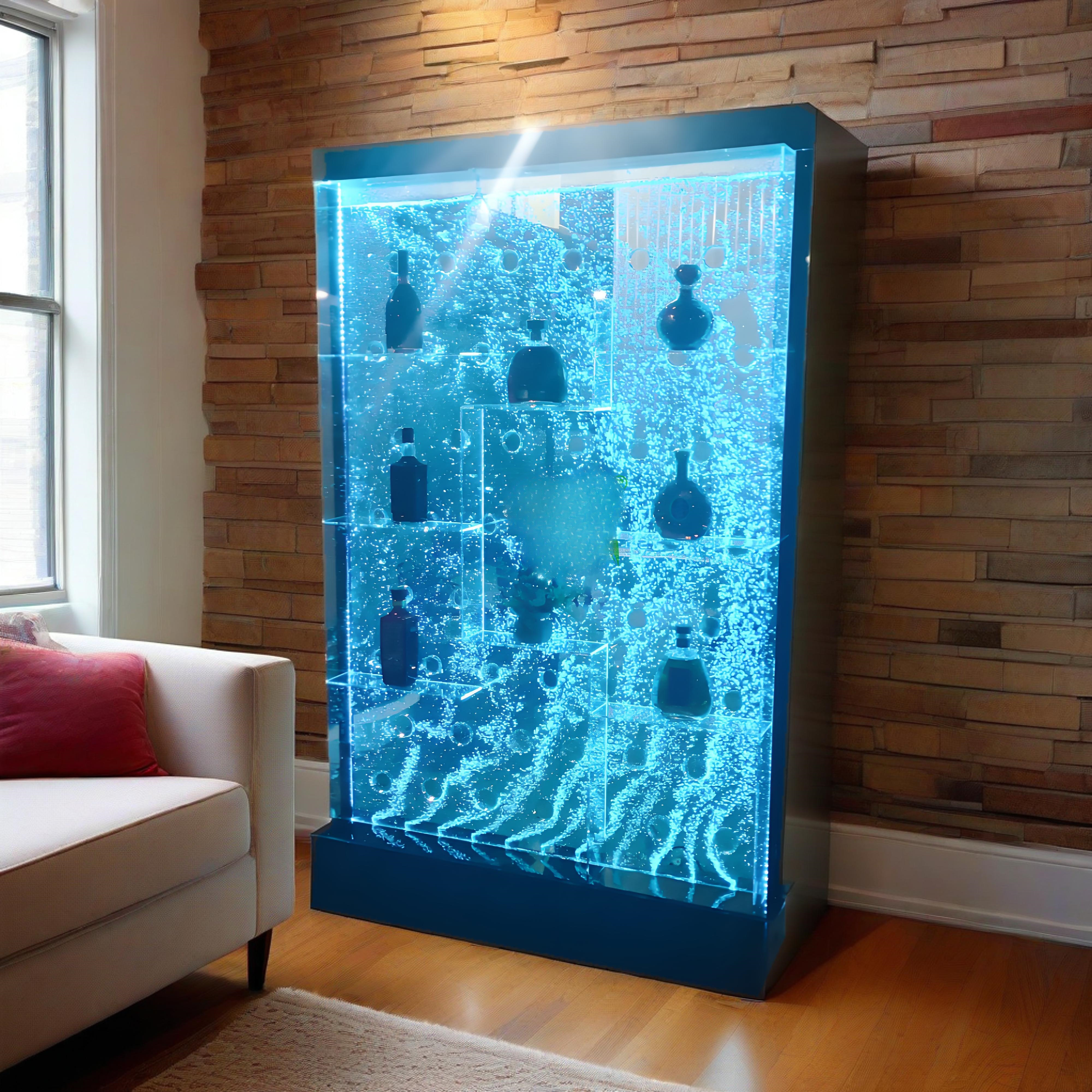 Futuristic blue glass display case with LED lighting in a room with wooden walls and a white sofa.