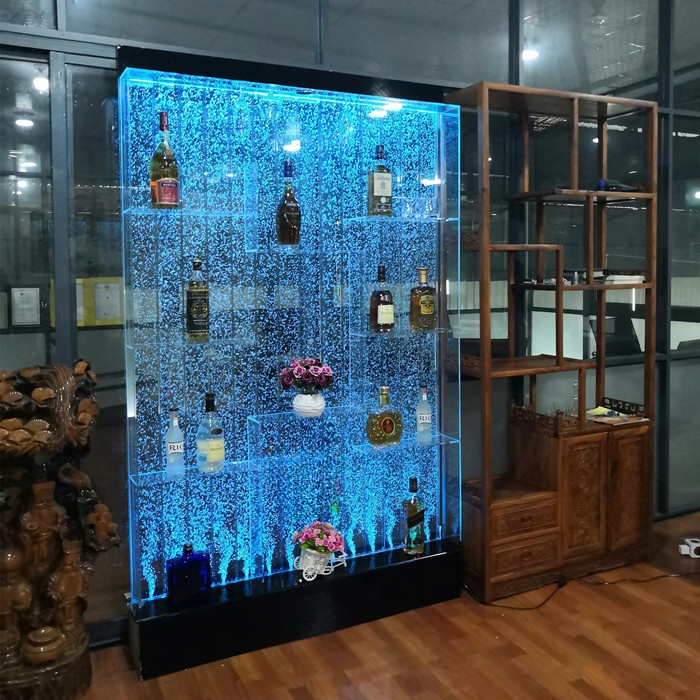 LED lighted wall with bottles and decorative elements in a room setting
